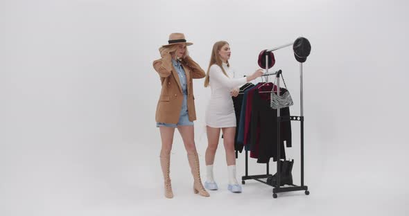 Stylist Dresses A Model In Fashionable Clothes For A Photo Shoot