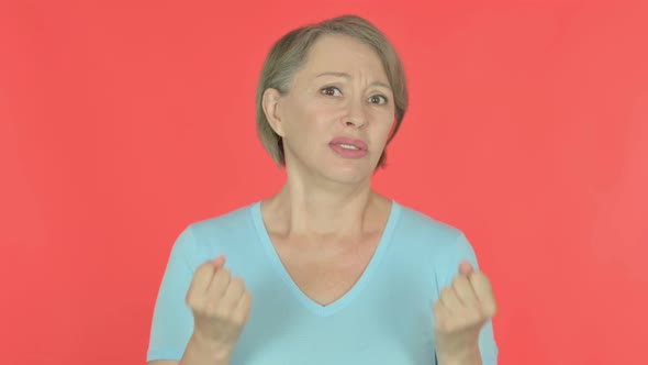 Disappointed Old Woman Reacting Loss on Red Background alt