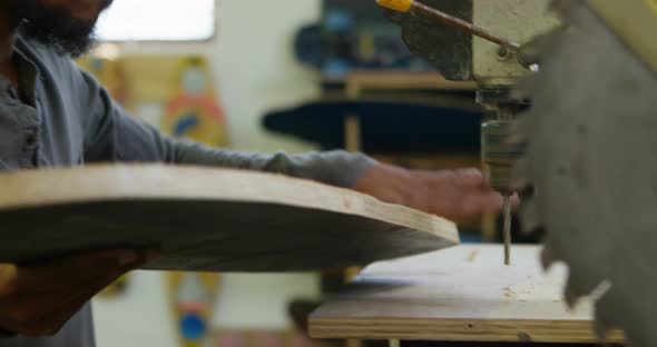 Man checking skateboard  alt