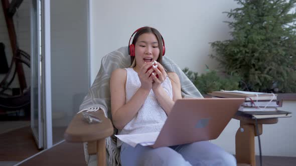 Cheerful Slim Beautiful Asian Woman Catching Healthful Apple Typing on Laptop Keyboard in Home alt