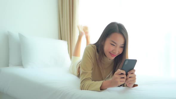 Young asian woman use smart phone alt