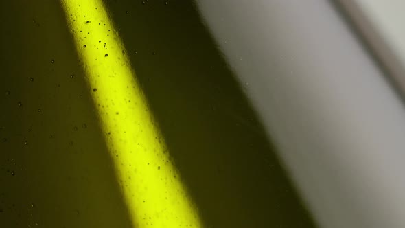 A dark bottle of cider. Bubbles Floating. Macro shot. alt