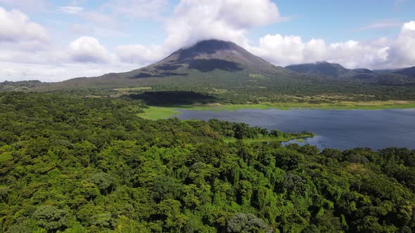 Trucking cameraement in aerial footage of Costa Rica's youngest and most active volcano. Big clouds alt