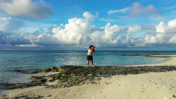 Lady sunbathing on idyllic coast beach break by transparent sea with bright sandy background of the  alt