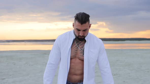 Brutal Man Walking on Beach