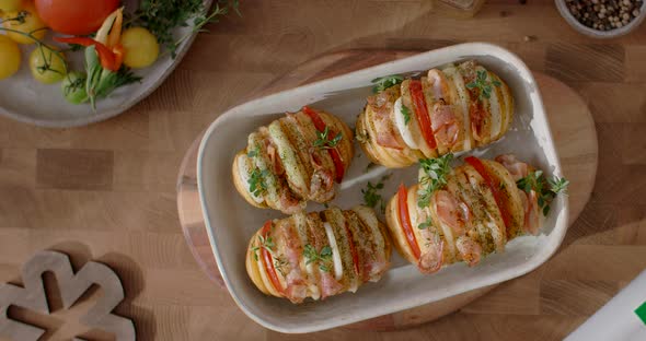 Tabletop Footage the Dish of Potato and Meat is Sprinkled By the Raw Greens and Herbs in Slow Motion alt