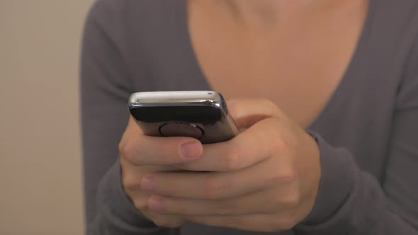 Woman holding mobile phone in hands and typing messages dolly 4K 2160p UHD video - Female with smart alt