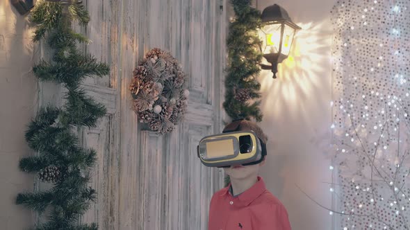Child in Red Shirt with Yellow VR Glasses Gestures Near Door alt