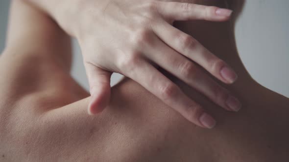 Naked Female Body. the Girl Touches Her Neck and Shoulders. Back View alt