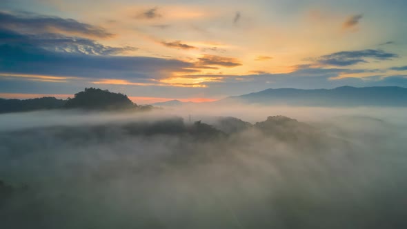 Hyper lapse Drone flight over the clouds during sunrise.