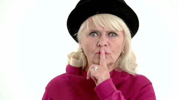 Elderly Woman Showing Silence Gesture alt
