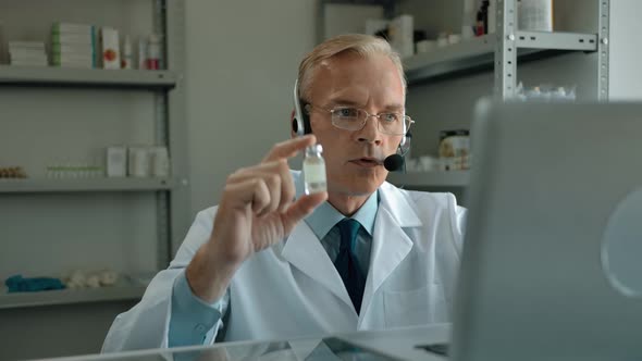 Senior Man in Headset Supporting Customers with COVID19 Vaccine Online alt