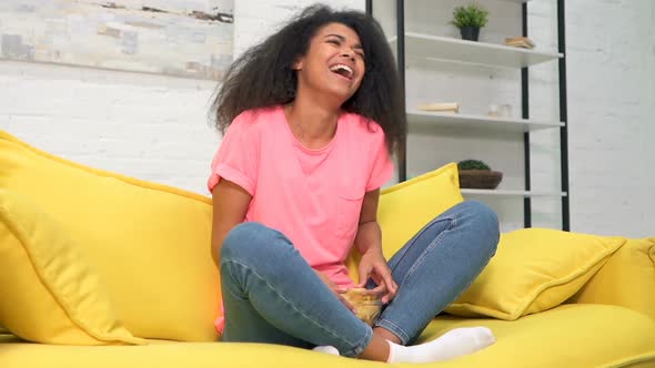 Laughing, smiling woman watching comedy film.