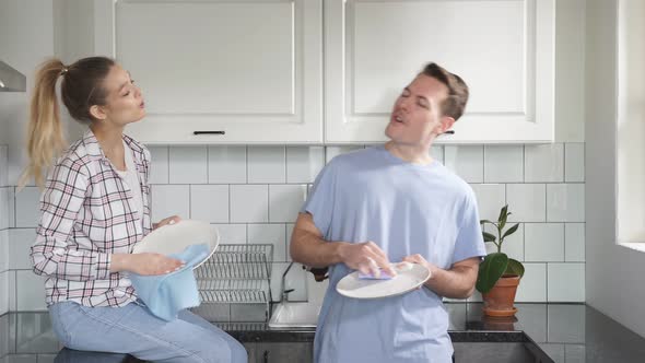 Cheerful Caucasian Couple Washing Dishes Together Indoors Keeping House Tidy