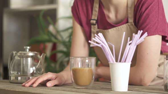 The Bartender Girl Pondered At Her Work Place. The Hand Knocks On The Textured Wood Of The Tabletop. alt
