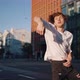 Young Man Demonstrates Dance Moves with Hands on City Road - VideoHive Item for Sale