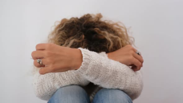 Intimidated woman showing word Stop on her palm alt