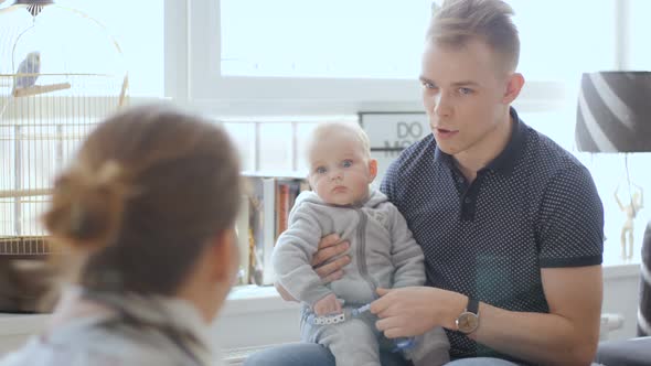Young Father Explaining Parenting To Other Person