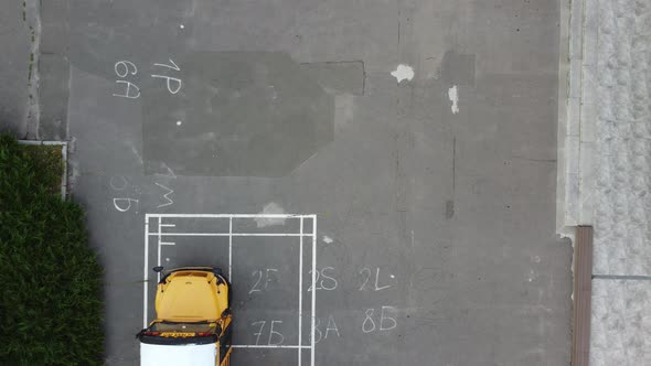 School Bus Parked at Entrance of Public School Building alt