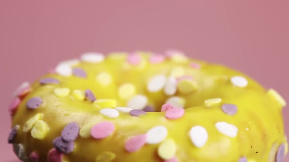 Donut Yellow Icing Pink Background