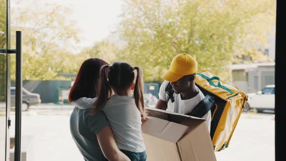 Opening the Parcel a Happy Child Takes a Fluffy Teddy Bear Toy Out of the Box alt