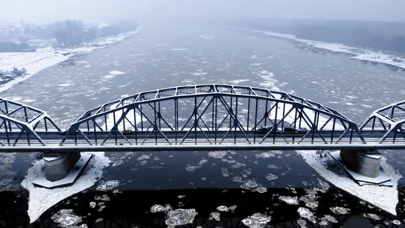 Bridge and river with floes. Transport in winter. Aerial view alt