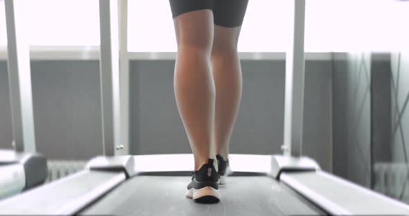 Back View of Black Shoes Having Workout on Treadmill