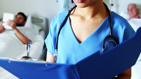 Portrait of female doctor holding medical report alt