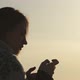 Beautiful Girl Standing at Dawn and Using Phone - VideoHive Item for Sale