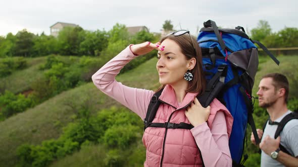 Happy Couple Man and Woman in the Mountains Travel in Search of a Vacation Spot alt