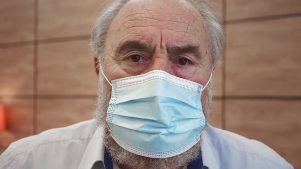 Close up portrait of charming mature man in medical face mask. Face of middle aged person. Older gen alt