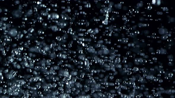 Super Slow Motion Shot Flying Water Drops Isolated on Black Background at 1000Fps alt