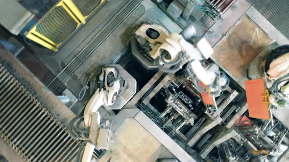 Top View of Factory Robots Processing Copper Plates alt