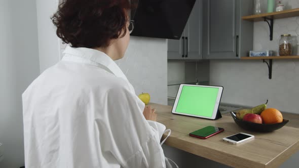 Woman Employee Talking Digital Tablet Green Screen Having Online Meeting Video Calling and Shaking