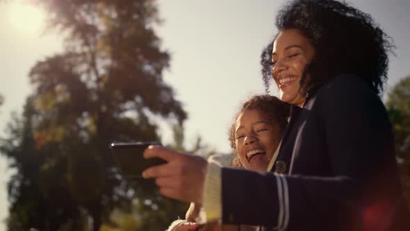 Laughing Mother Holding Smartphone Watching Funny Pictures Selfie Together Park alt