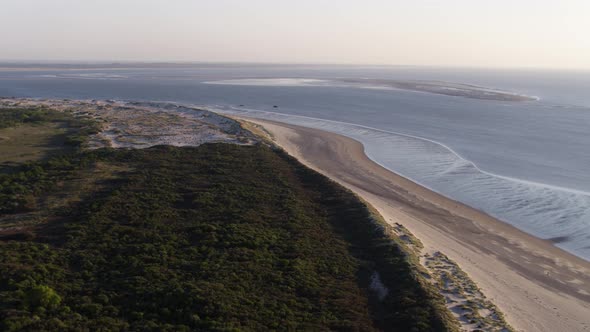 An onward aerial drone shot approaching the bay located near the Oostvoorne town in the Dutch provin alt