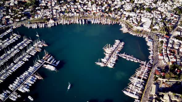 View from drone on full of yachts Bodrum harbour and ancient Kalesi castle in Mugla in Turkey alt