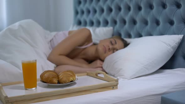 Girl Sleeping in Hotel Room, Ready Breakfast on Tray Near Bed, Five Star Service alt