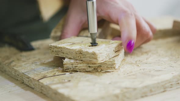 Woman Driving Screw Into Chipboard with Gun alt