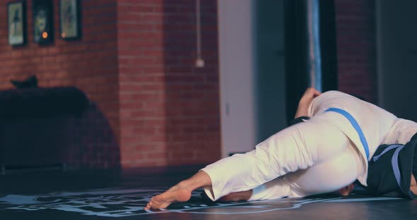 Man in a Kimono Makes a Grab of the Enemy and Throws Him to the Floor Painful Reception on His Arm alt