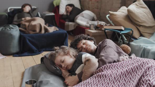 Mother and Son Sleeping in Flee Camp alt