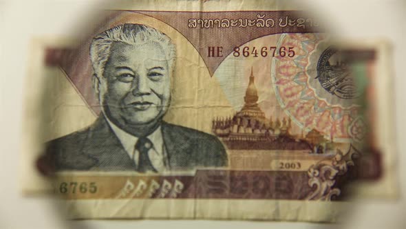 Five thousand Lao Kip and a magnifying glass.