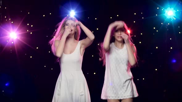 Girls Are Dancing Making the Similar Gestures and Blowing Kisses alt