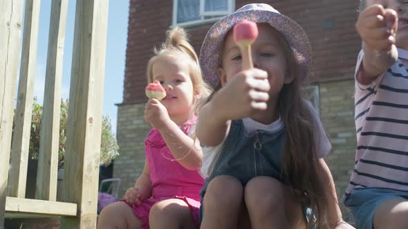 Three Cute Little Children Enjoys Delicious Ice Cream Cone
