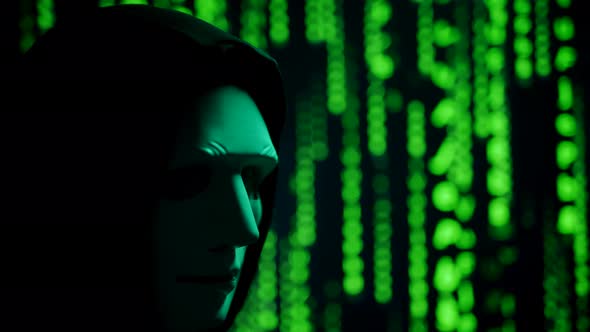 Close Up of a Anonymous Computer Hacker in Black Hood and Mask Over Abstract Binary Matrix alt