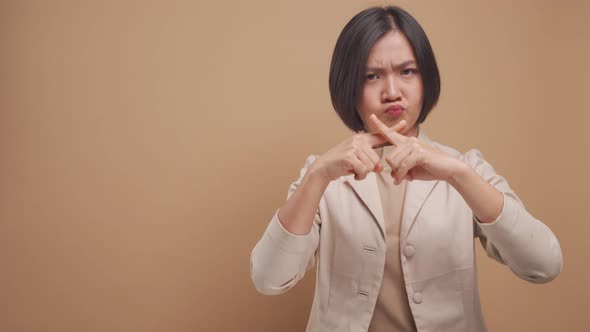 Asian business woman angry and crossed arms showing stop sign standing with copy space isolated