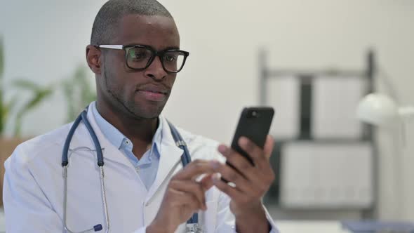 African Doctor Using Smartphone in Clinic alt