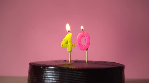 Chocolate Birthday Cake with Wick Lighting Trying to Blowout Candle alt
