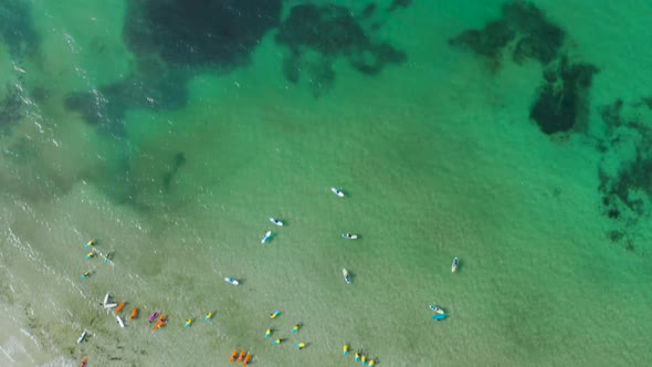 People surfing and paddle boating on the beach, The endless sea landscape alt