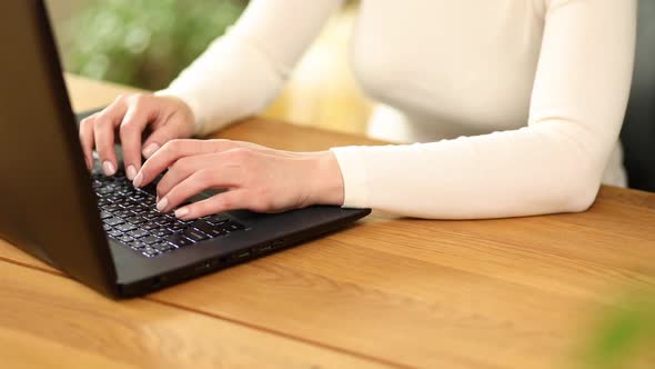 Unrecognizable Hand Female Chatting Online in Social Network Using Typing on Laptop